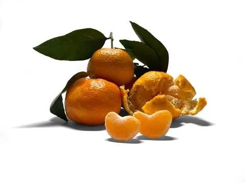 On a white background lies a small bunch of tangerines. Stock Photos