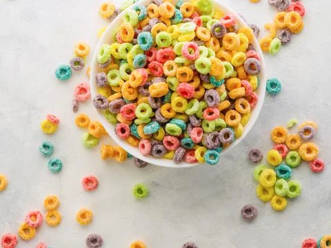 On a white background, multi-colored fruit cereal rings. High angle view. Qui Stock Photos