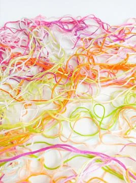 White background, multicolored tangled threads and yarn. Stock Photos