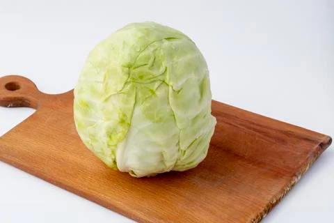 White background. No isolation. Head of fresh cabbage on a cutting board. Clo Stock Photos