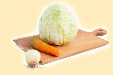 White background. No isolation. Head of fresh cabbage, carrots and onions on  Fotos Stock