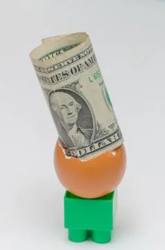 On white background, one dollar in an egg shell Фото
