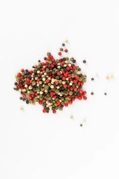 On white background a pile of mixed large aromatic peppers black red and white Stock Photos