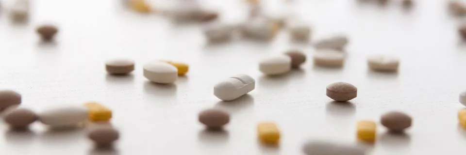 White background with randomly scattered tablets. Stock Photos