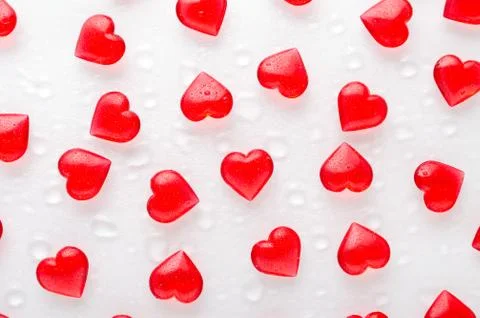White background with red hearts pattern and water drops, flat lay Stock Photos