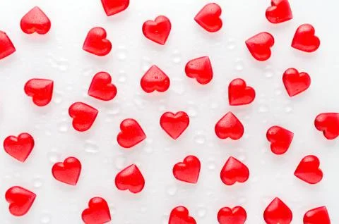 White background with red hearts pattern and water drops, flat lay Stock Photos