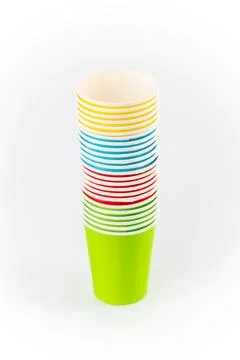 White background, a stack of paper cups for coffee and tea painted in red, green Stock Photos
