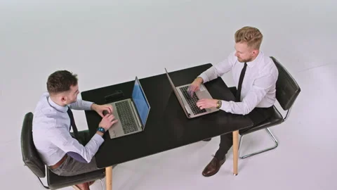 White background studio two workers men wearing business clothes sitting on the Stock Footage 131561887