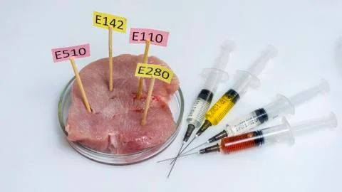 White background, the study of meat. Tablets with nutritional supplements E. Stock Photos