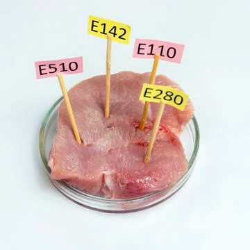 White background, the study of meat. Tablets with nutritional supplements E.  Stock Photos