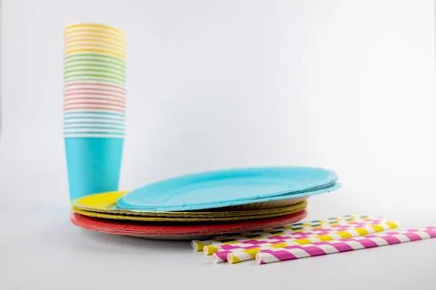 On white background there are three paper cups yellow red and blue with matching Stock Photos