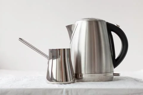 On a white background there is an iron electric kettle and an iron turk. Coff Stock Photos