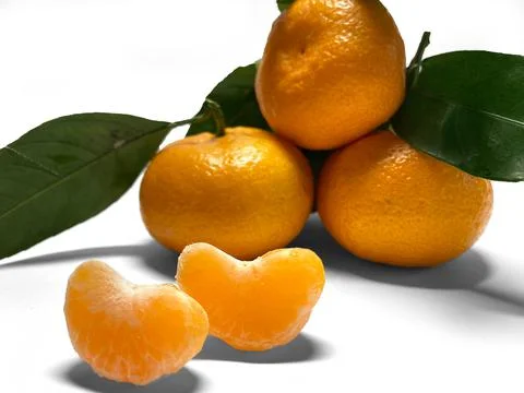 On a white background, three tangerines lie in the shape of a pyramid. Stock Photos