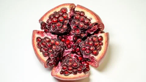 White background, top view, an open pomegranate is in the middle of the photo Stock Photos