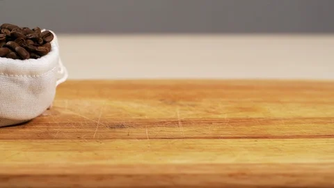 White bag fall from roasted coffee grain slowmotion closeup spill arabica table Stock Footage 113074809