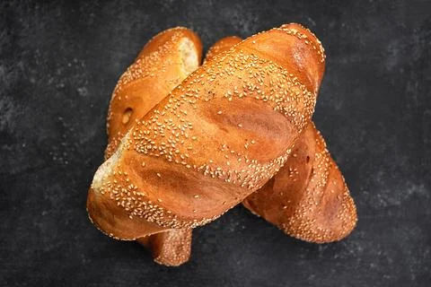 White baked bread with seeds, on gray concrete Stock Photos