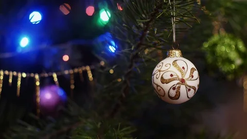 A white ball with a pattern hangs on a Christmas tree  Stock Footage 121848104