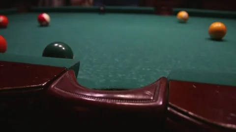 A white ball with a red stripe flew into the pocket of a billiard table Stock Footage 339029209