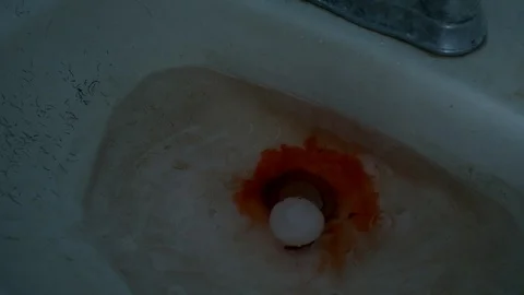 White ball with tracking marks dropping into bloody sink Stock Footage 103062512