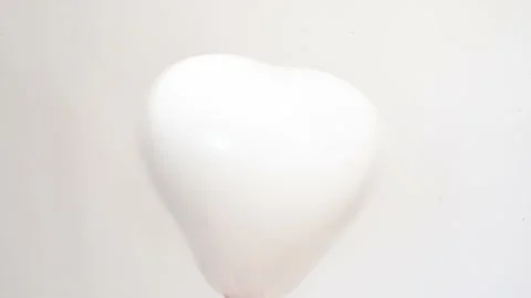 White ballon in shape of heart on white background, studio 4k footage. St.Valent Stock Footage 232023436