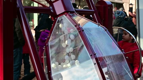 White Balls Droping in a Huge Decorative Sandglass on Street Stock Footage 232960321
