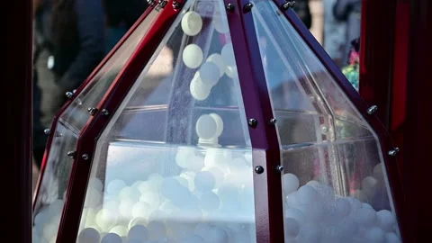 White Balls Droping in a Huge Decorative Sandglass on Street Stock Footage 232960322