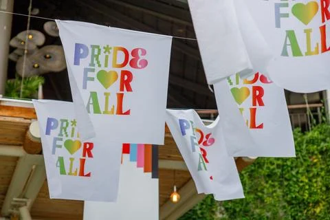 A white banner with the words "Pride for All" in colorful rainbow letters, .. Stock Photos
