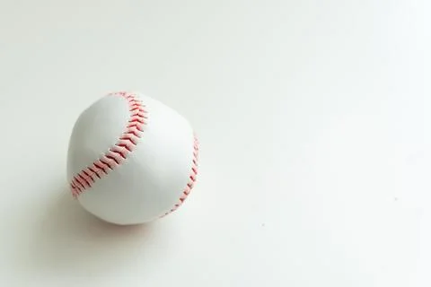 White baseball ball with red threads on white paper background Stock Photos