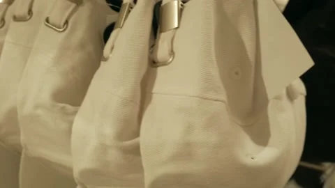 White baseball caps hanging on a hanger in a store 스톡 동영상 130662004