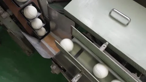 White Baseballs Rolling Down Conveyor Chutes Overhead View Stock Footage 339736703