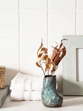 White bath background with ceramic vase, white towels and decor on white shel Stock Photos