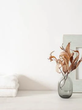 White bath background front view with glass vase, white towels and decor on w Stock Photos