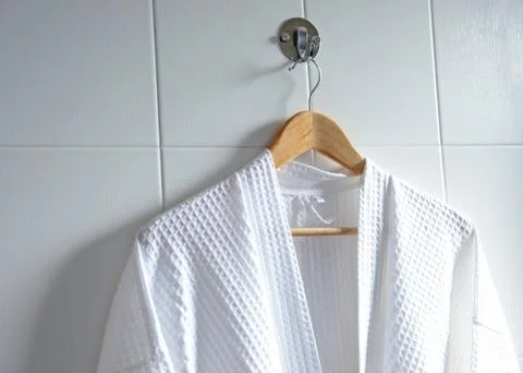 White bathrobe on hanger Stock Photos