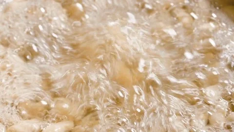 White beans bubbling in water Video stock 72956312