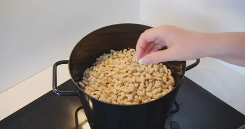 White beans cooked in black pot on stove Stock Footage 144636311