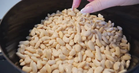 White beans cooked in black pot on stove Stock Footage 144636622