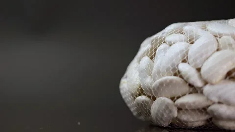 White beans in a macro view, slowly spinning against a black canvas, emphas.. Video stock 263027562