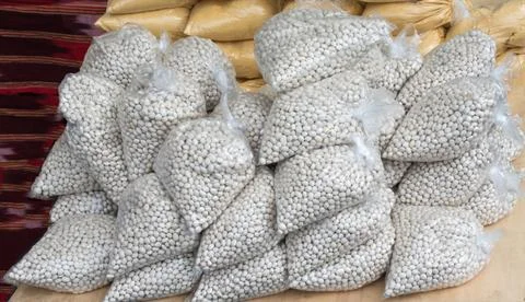 White beans in plastic packaging on display Stock Photos