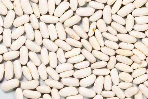 White beans scattered on the table for manual separation Stock Photos