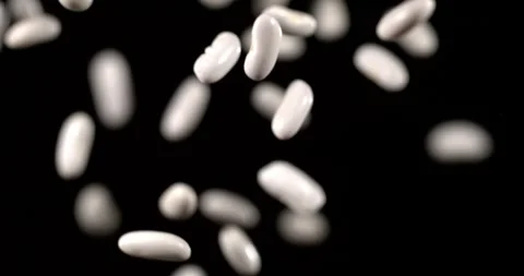 White Beans Tossed in Ultra Slow Motion on Black Background Stock Footage 344985771