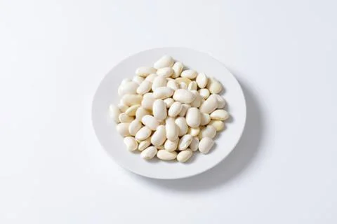 White beans on a white plate Stock Photos