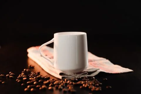 A white beautiful cup of tea or freshly brewed coffee is standing on a beauti Stock Photos