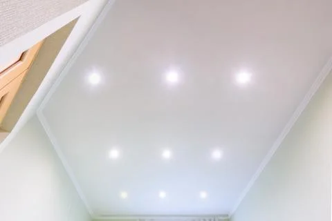 White beautiful matte stretch ceiling in the interior of the hall Stock Photos