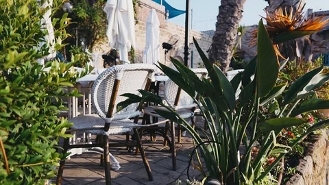 White beautiful summer empty open air cafe in Jaffa, Israel, crane shot. Stock Footage 98351461