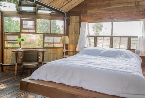 White Bed and Work Table in Country Loft Interior Design Room Stock Photos