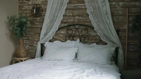 White bed with crumpled sheets and pillows in luxury hotel room Stock Footage 320824724