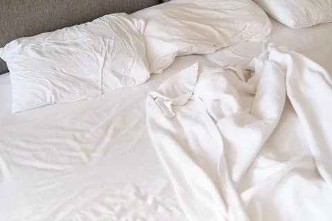 White bedding in disarray, intimate and personal angle. Aligns with the move Stock Photos