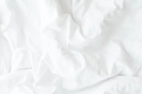 White bedding sheets or white fabric wrinkle texture background,soft focus Stock Photos
