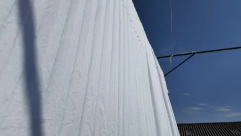 White Bedsheets Drying in the Mountain Breeze on a Hostel Rooftop in Dali, .. Stock Footage 340516859