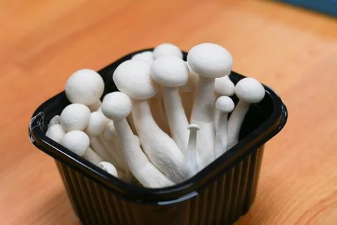 White beech mushroom inside a black plastic box. Stock Photos
